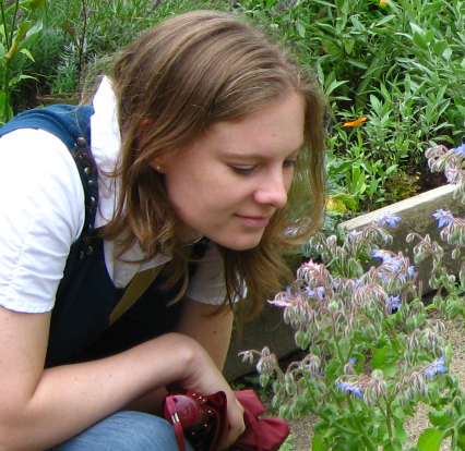 Sarah stops to smell some flowers at a public garden in Aarhus, Denmark.