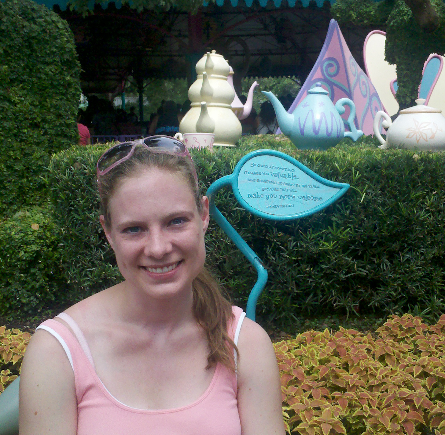 Sarah sits near the plaque honoring Randy Pausch at the tea cup ride at Disney Land.