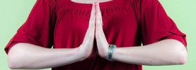 A close up of Sarah's hands in prayer pose.